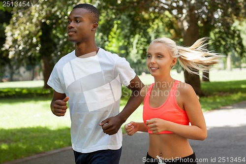 Image of young couple runner jogger in park outdoor summer