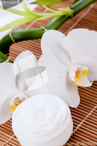 Image of cosmetic face cream on wooden background 