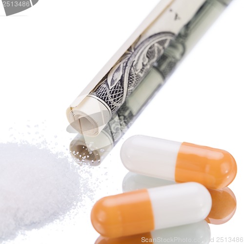 Image of illegal pharmaceutical pills and drugs money on mirror