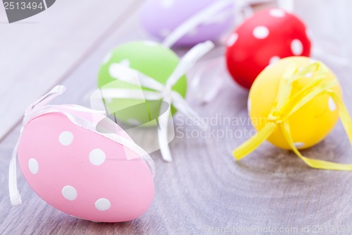 Image of colorful easter egg decoration on wooden background