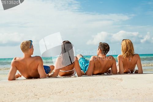 Image of young happy friends havin fun on the beach