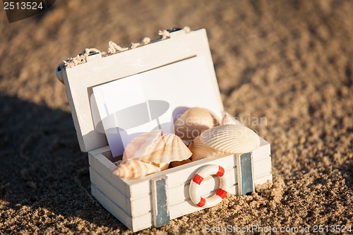 Image of sailing boat and seashell in sand decoration closeup