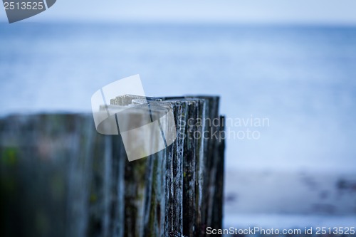 Image of baltic sea background evening wooden wave breaker beach