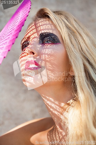 Image of young beautiful woman with smokey eyes and pink lips