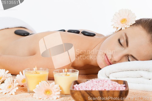 Image of attractive healthy caucasian woman hot stone massage wellness 