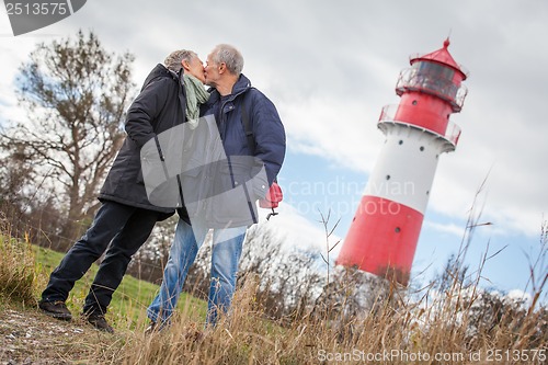 Image of happy mature couple relaxing baltic sea dunes 