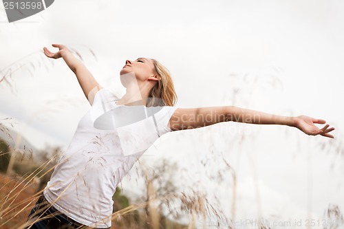 Image of young happy attractive woman arms wide open 