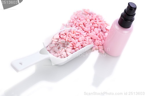 Image of pink body lotion in dispenser and aroma salt isolated