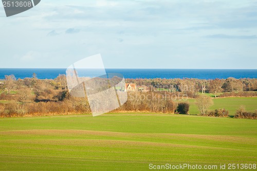 Image of beautiful landscape in autum baltic see green field blue sky