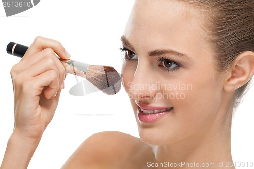 Image of apllying powder make up on face portrait