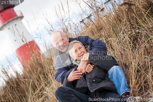 Image of happy mature couple relaxing baltic sea dunes 