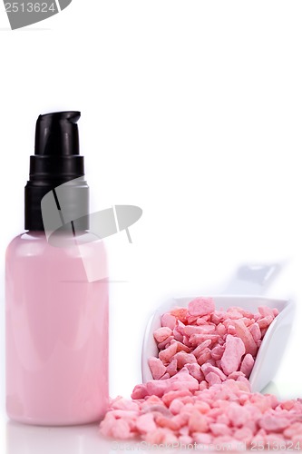 Image of pink body lotion in dispenser and aroma salt isolated