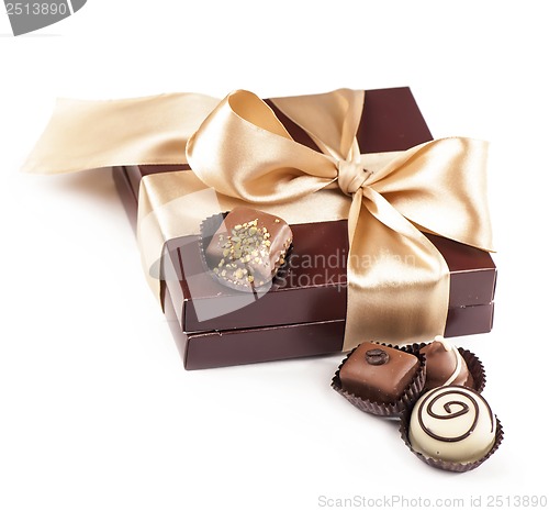 Image of brown box with candies and golden tape