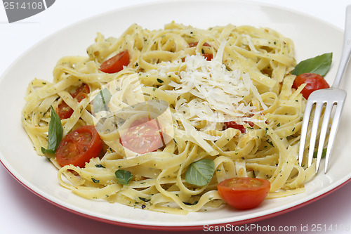 Image of Tagliatelle with pesto tomatoes and fork