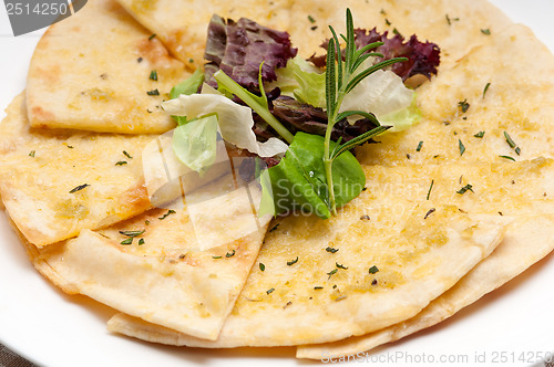 Image of garlic pita bread pizza with salad on top