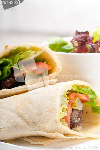 Image of kafta shawarma chicken pita wrap roll sandwich