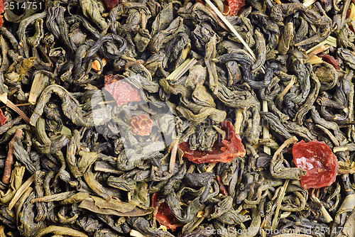 Image of green tea with  lemon peels flower petals and lime  flavour as background