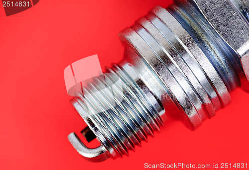 Image of spark-plug on the red background 