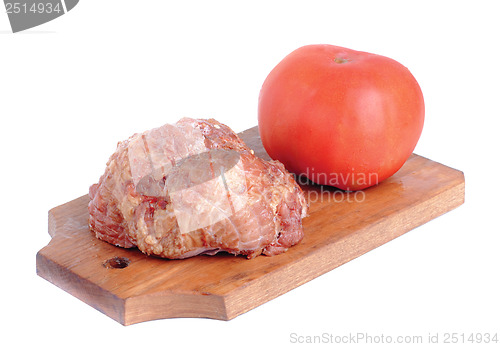 Image of Meat product.and tomato   on a cutting board on white