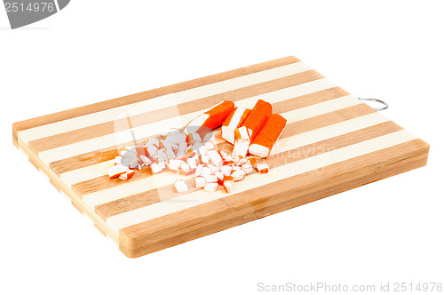 Image of sliced crab sticks on  cutting board