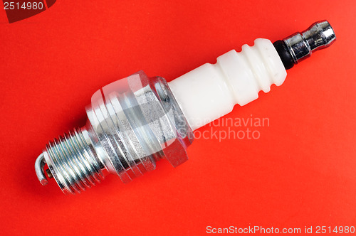 Image of spark-plug on the red background 