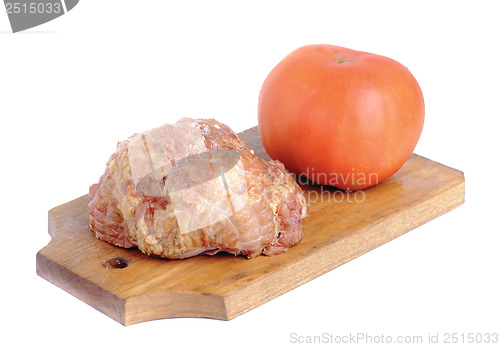 Image of Meat product.and tomato   on a cutting board on white 