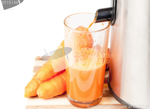 Image of Juice machine and carrot juice isolated  on  white