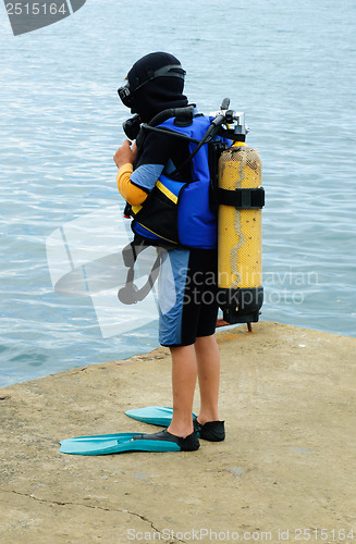 Image of Little scuba diver , before diving into  sea