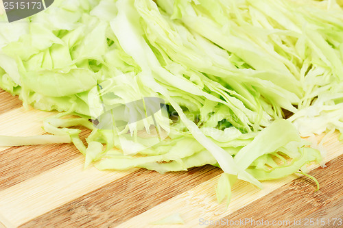 Image of Green  cabbage sliced  on  cutting  board