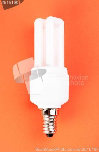 Image of energy saving light bulb on red background 