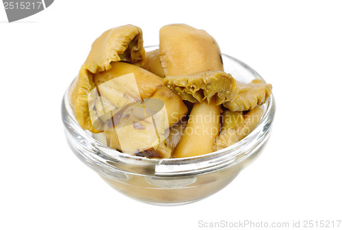 Image of  pickled mushrooms in glass bowl  isolated on  white