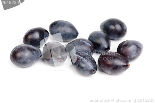 Image of Some fresh blue plums on the white background 