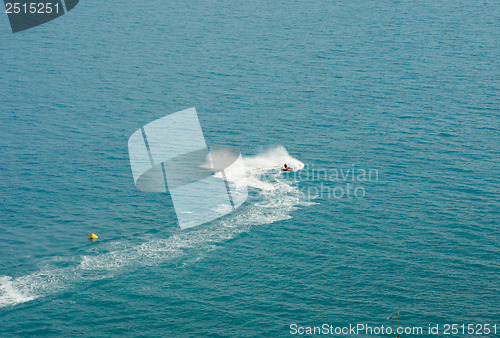Image of white  trace  water motorcycles on blue sea surface 
