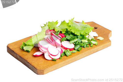 Image of Fresh slised radish, onion and salad on cutting board isolated on white 