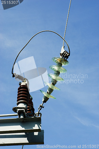 Image of Insulators on a high voltage electric pillar   jn the  blue sky background