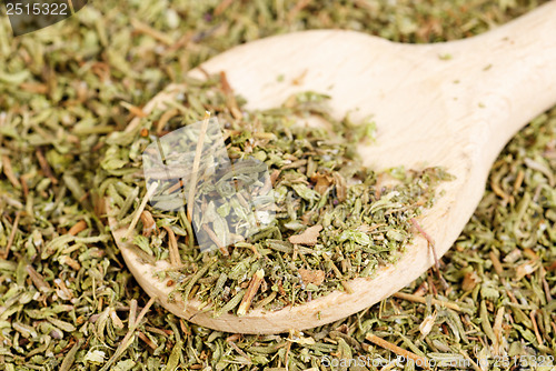Image of herb thyme and wooden spoon as background 