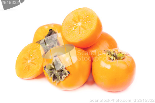 Image of Persimmon fruit whole and sliced on white background