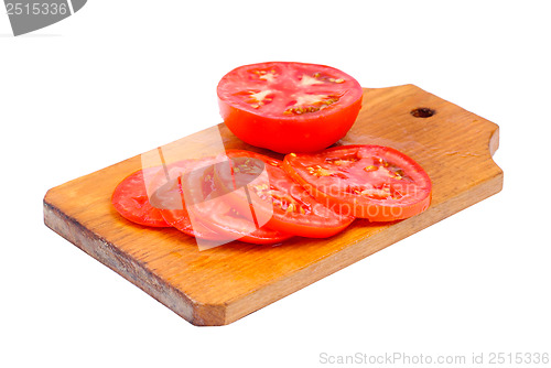 Image of whole and sliced fresh red tomatoes on  cutting board isolated on white background 