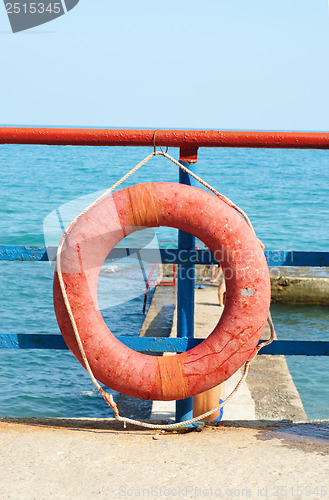 Image of Red Lifebuoy in front of the blue sea