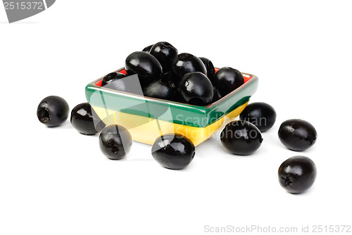 Image of Black pitted olives in ceramic salad bowl isolated on white macro