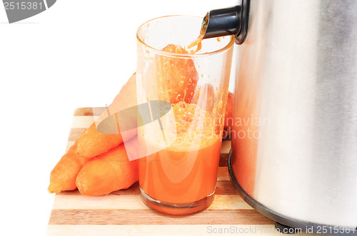 Image of Juice machine and carrot juice isolated  on  white