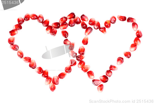 Image of pomegranate seeds as heart shaped  isolated  on  white