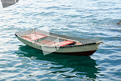 Image of Lifeboat with paddle. Old wooden boat 