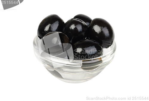 Image of Black pitted olives in glass isolated on white macro 