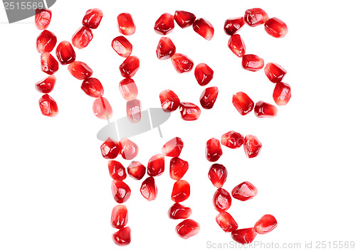 Image of word of kiss me  from the seeds of a pomegranate isolated on  white