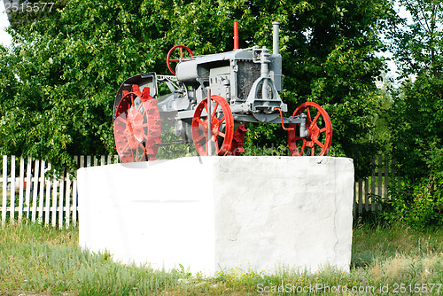 Image of An old tractor on a white pedestal.Ukraine. Poltava  region.