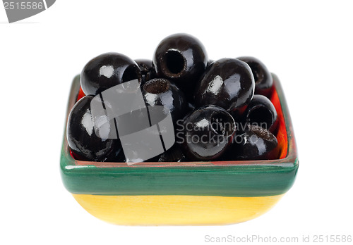 Image of Black pitted olives in colored ceramic ware isolated  on  white