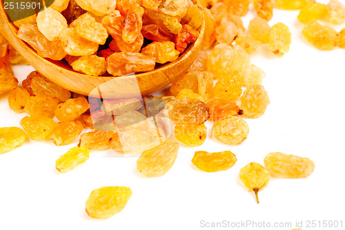 Image of Golden raisins close- up and wooden spoon, isolated on white background 