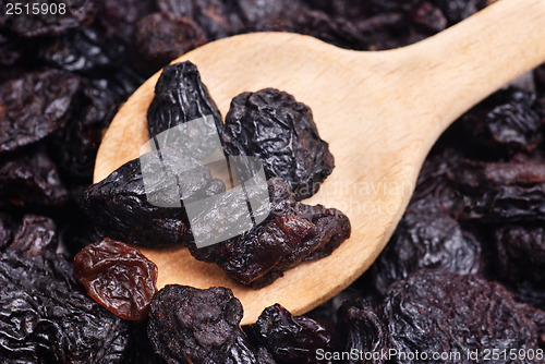 Image of raisins and  wooden  spoon close- up food background 