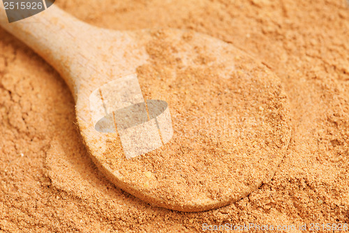 Image of Cinnamon  powder and wooden spoon as  nature  food   background